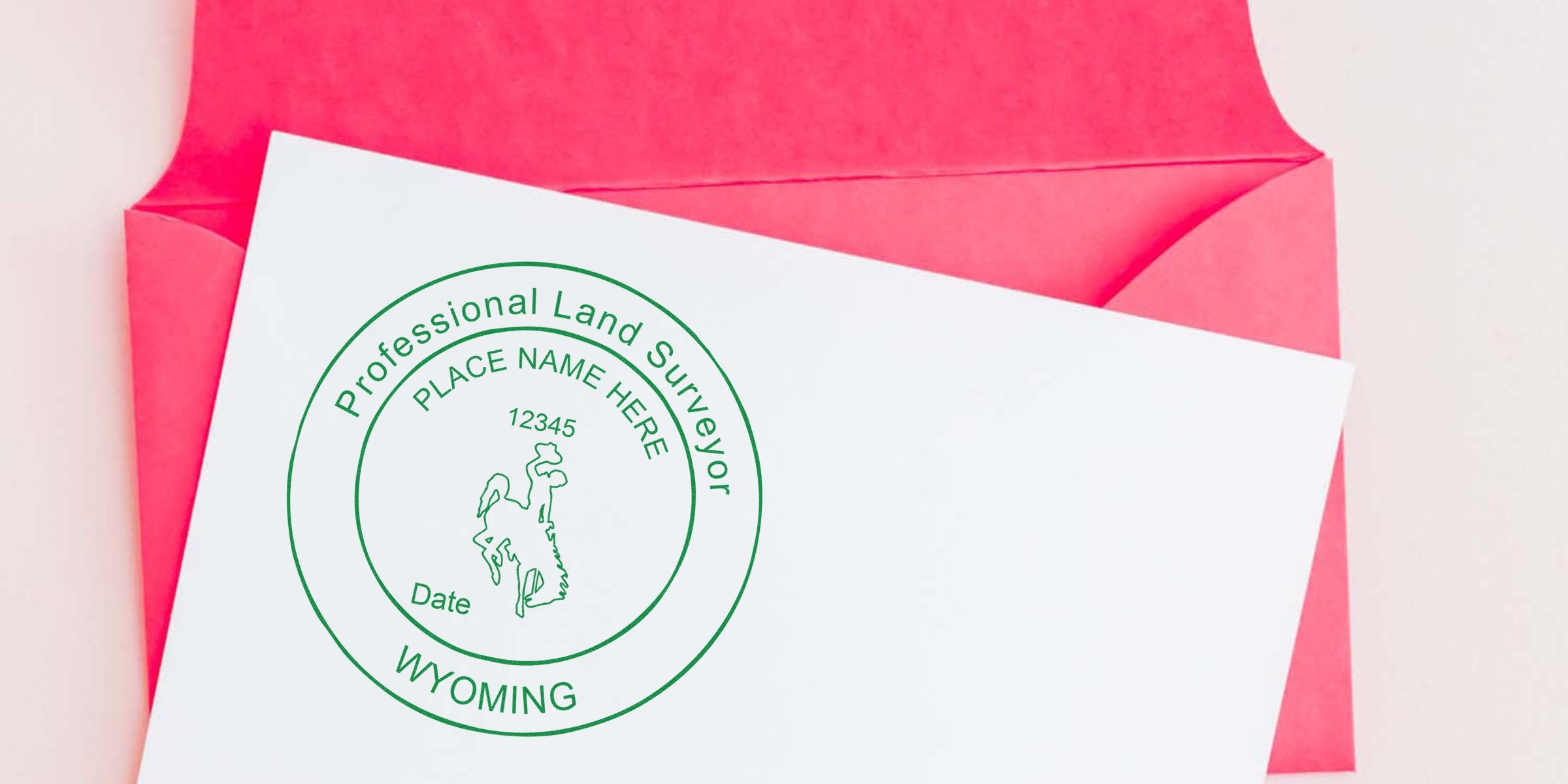 Wyoming land surveyor seal stamped on white paper with a pink envelope background, emphasizing professional land surveyor standards.