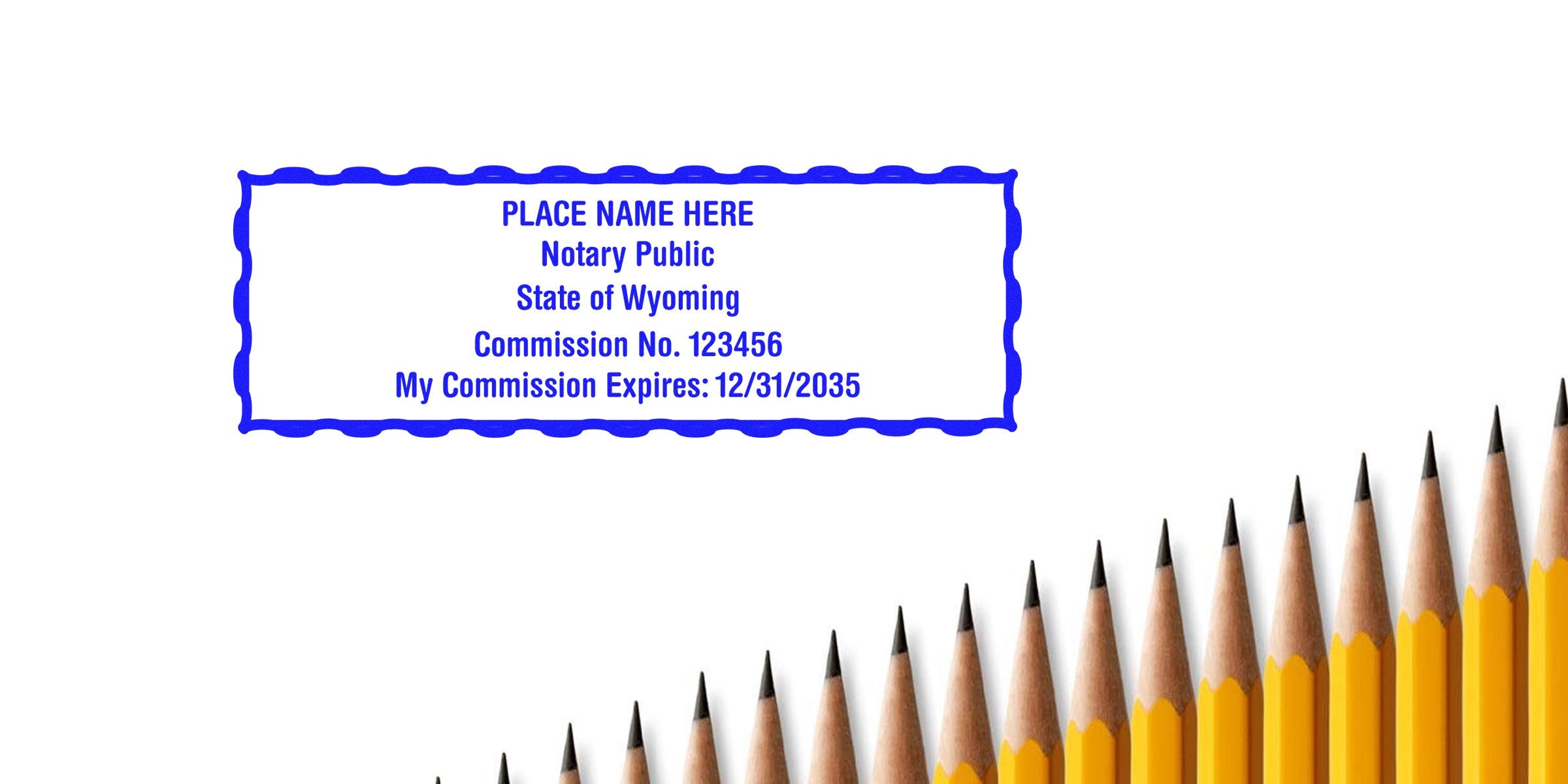 Wyoming notary seal stamps with commission number and expiration date, displayed above sharpened yellow pencils, highlighting affordable notary supplies.