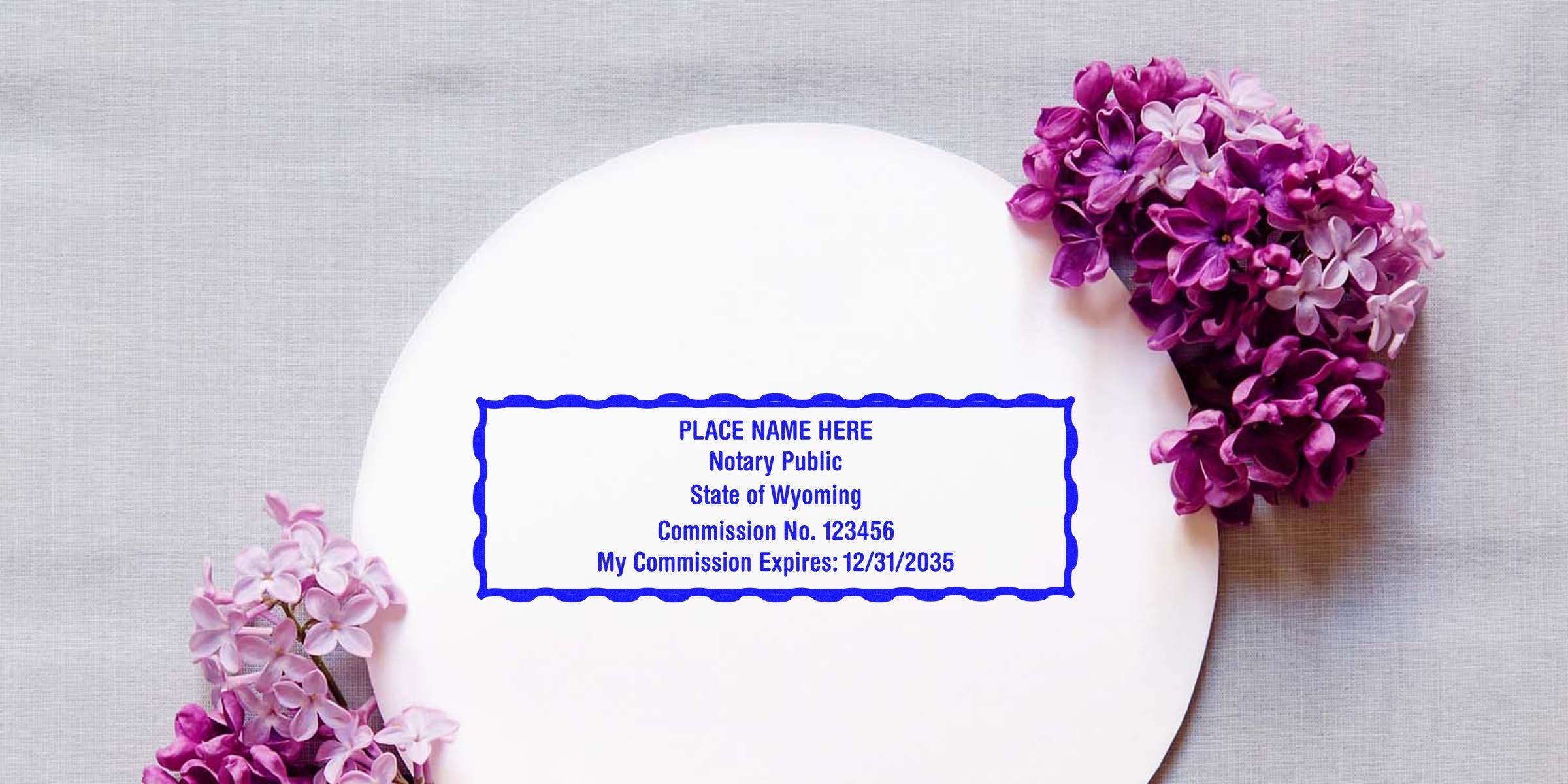 Wyoming notary seal with commission number and expiration date, surrounded by purple lilac flowers on a white plate, plus tips for buying a notary seal.