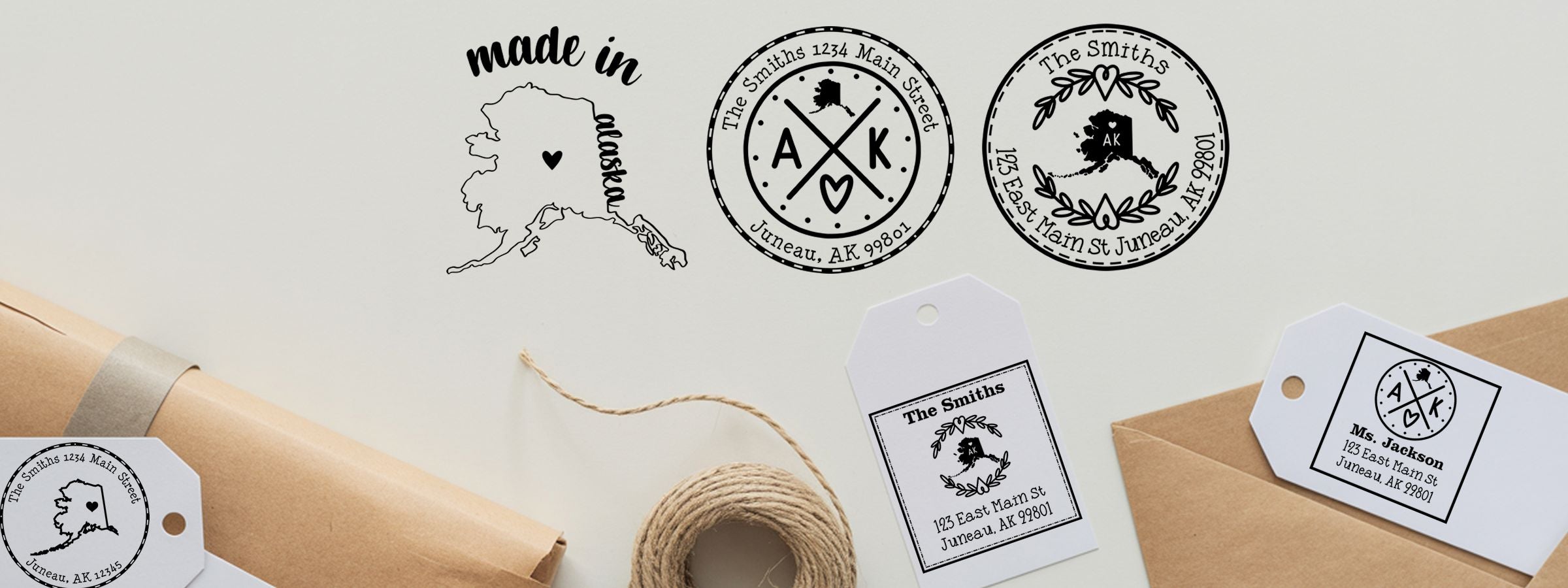Alaska Designer Stamps and Seals mockup with black-and-white The Smiths address labels, Alaska map heart, gift tags, twine, kraft packages.