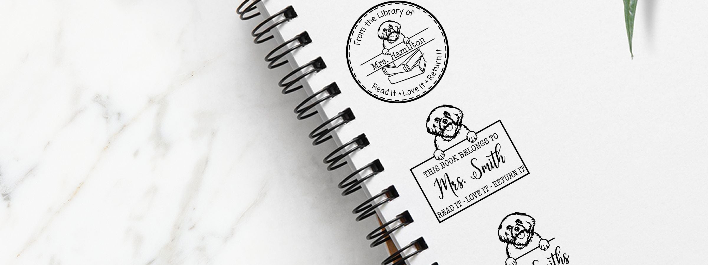 Notebook on marble with Bichon Frise Dog Stamps and Custom Seals reading “From the Library of Mrs. Hamilton” and “This Book Belongs to Mrs. Smith.”