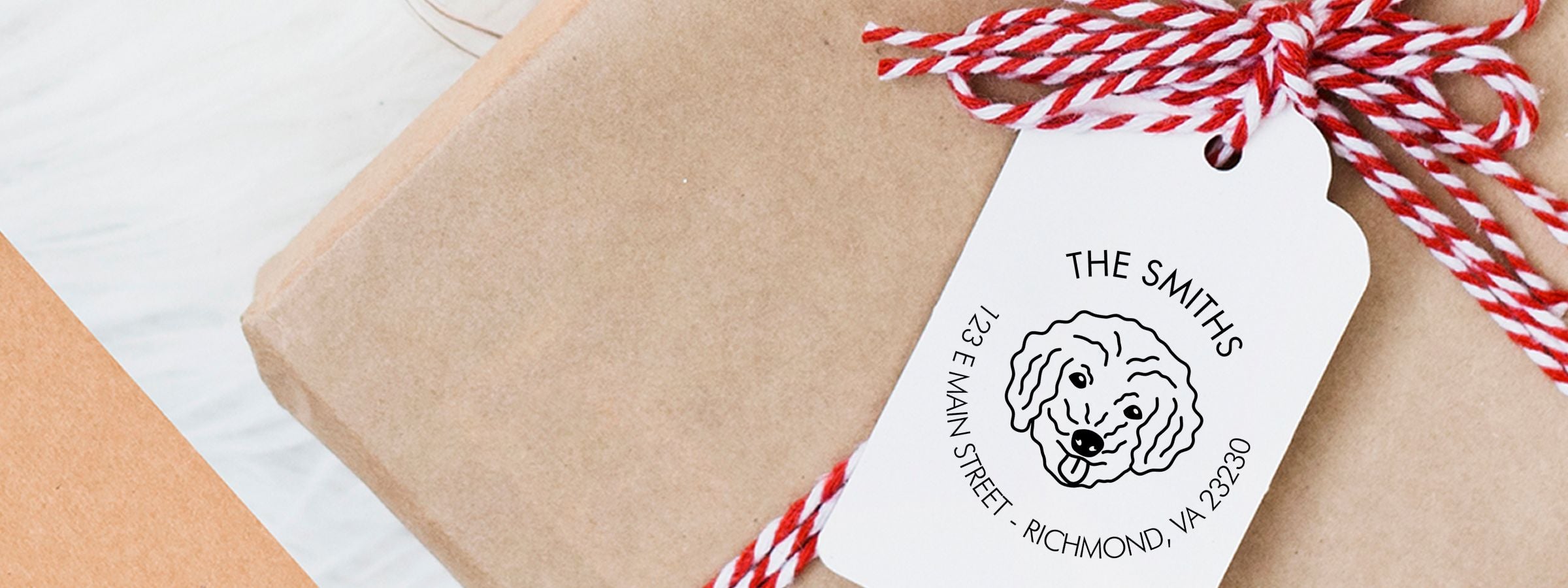 Wrapped gift bag with red-and-white twine and a Bichon Poo Dog Stamps and Custom Seals tag for The Smiths, Richmond, VA.