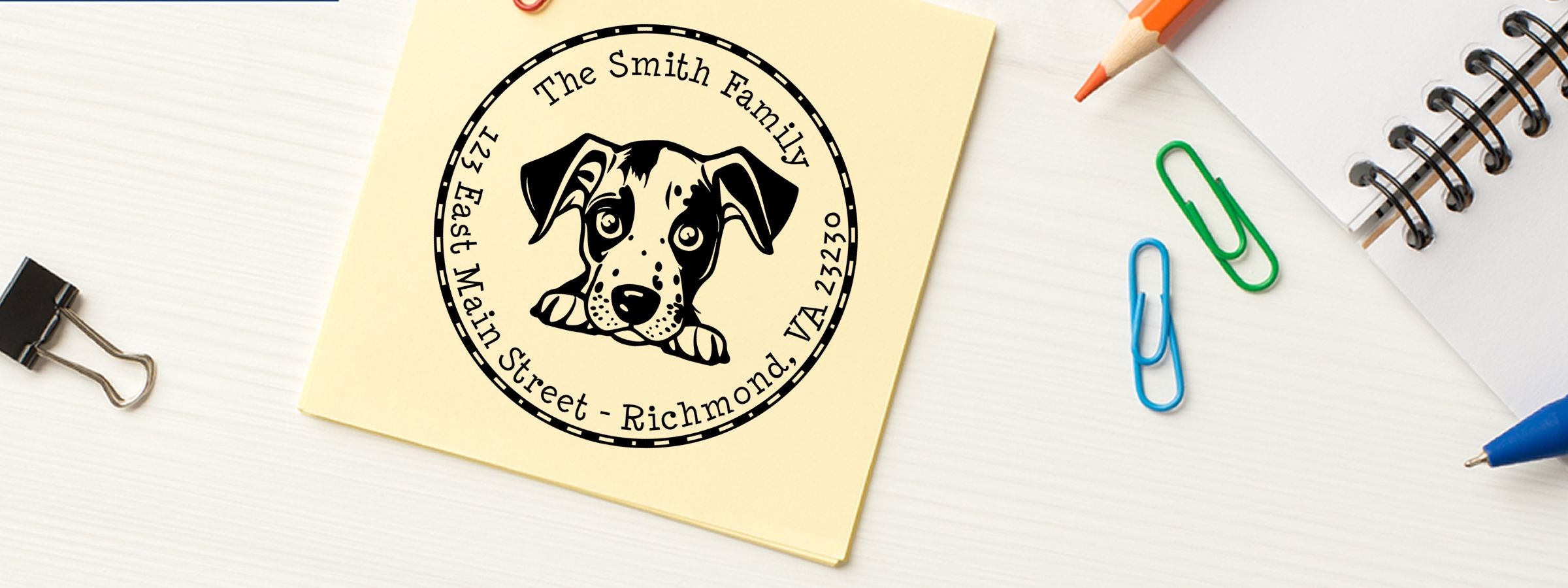 Yellow sticky note on a white desk with a black dog logo, The Smith Family address, and Catahoula Dog Stamps and Custom Seals.