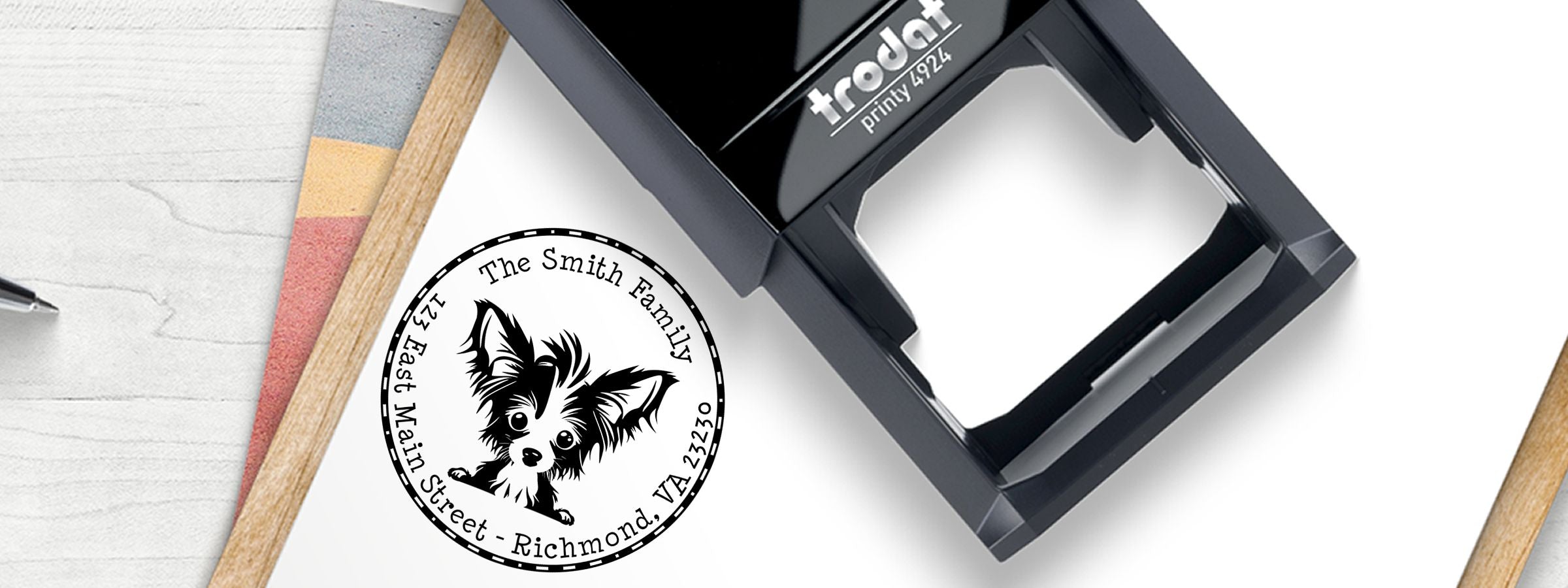 Black Trodat Printy 4924 self-inking stamp on a white desk with puppy logo, Smith Family address, Chinese Crested Dog Stamps and Custom Seals.