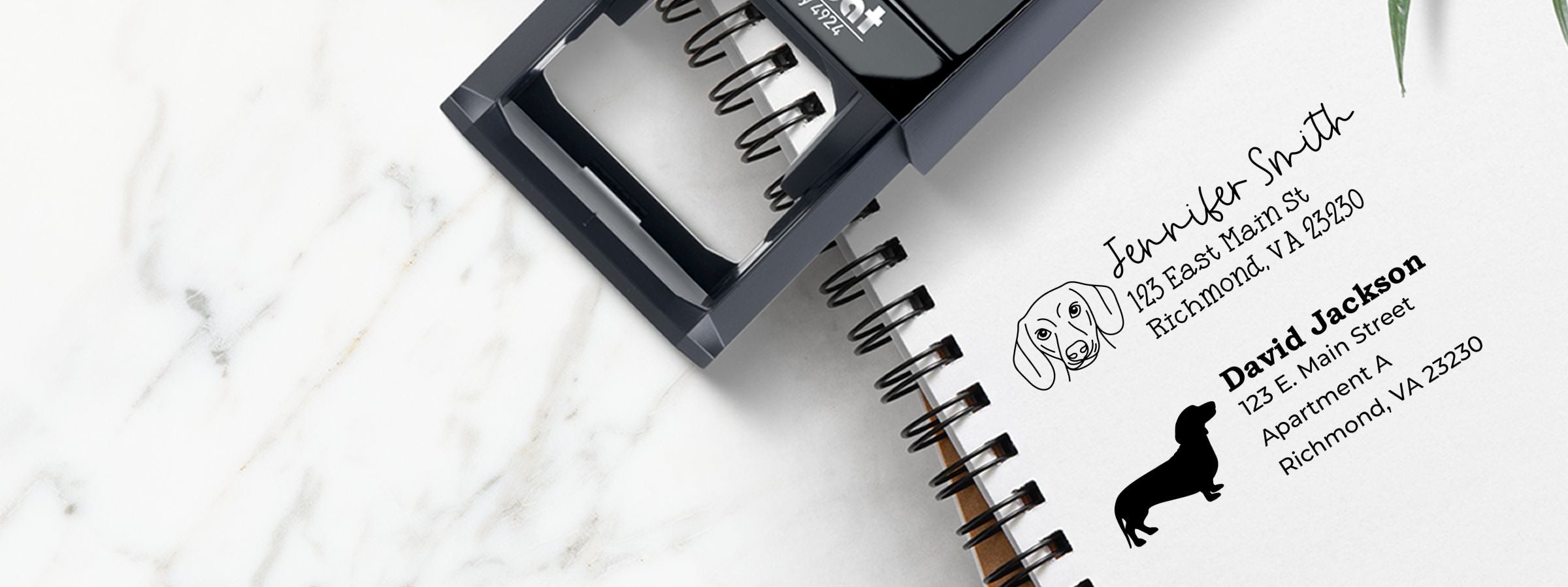 Black self-inking address stamp on notebook with pet return addresses for Jennifer Smith and David Jackson, plus Dachshund Dog Stamps and Custom Seals.