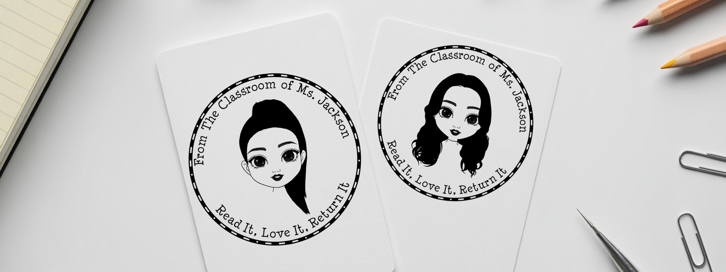 Emoji Designer Stamps on two white cards show “From the Classroom of Ms. Jackson” and “Read It, Love It, Return It” beside desk supplies.