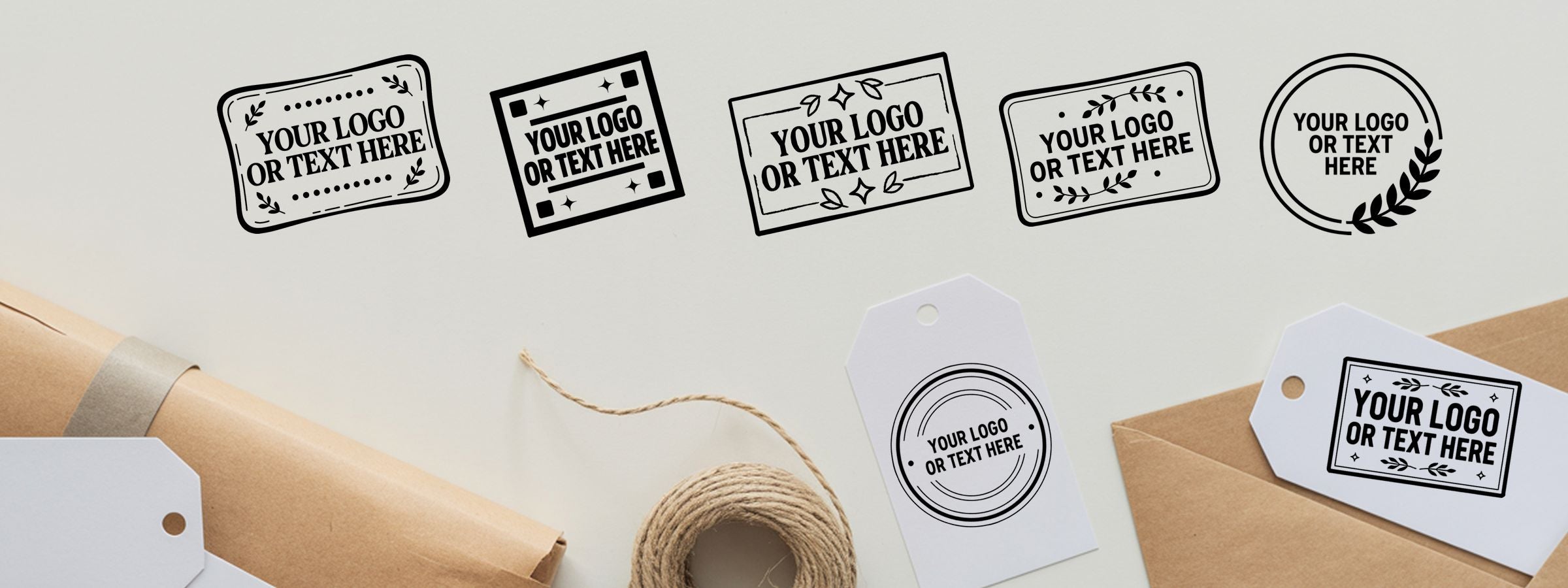Black-and-white logo label mockups on brown packages with hang tags and twine, featuring Extra Large Custom Stamps.