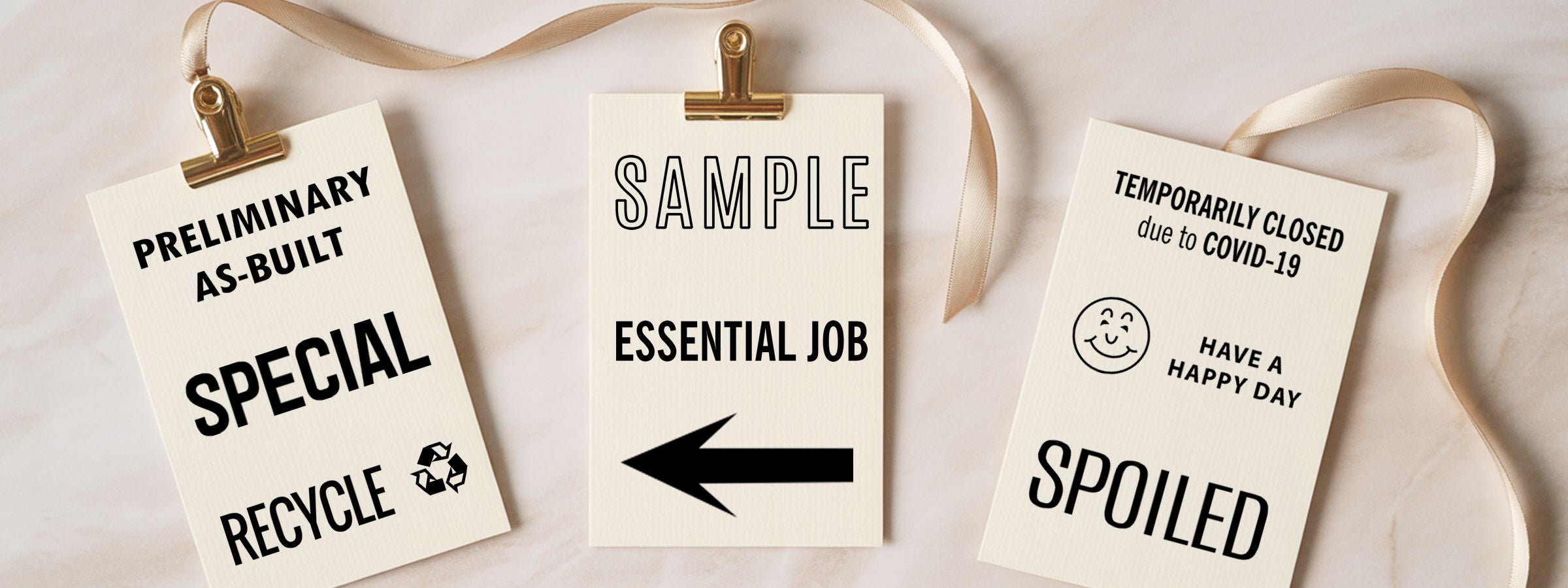 General Business Use Stock Stamps showing three cream cards clipped with gold ribbon, labeled as-built, essential job, and COVID-19 closed.