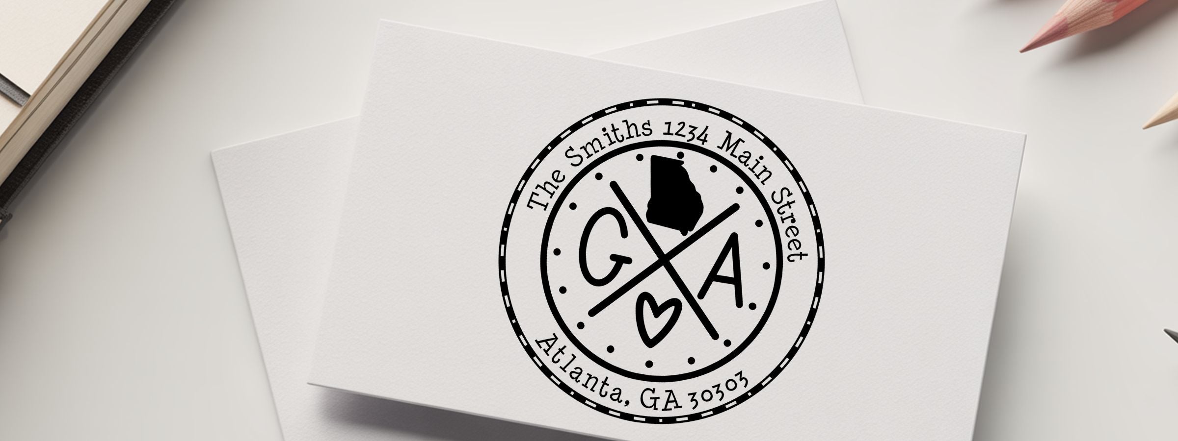 Georgia Designer Stamps and Seals white stationery card with black monogram, The Smiths address, Georgia silhouette, heart, and pencils.