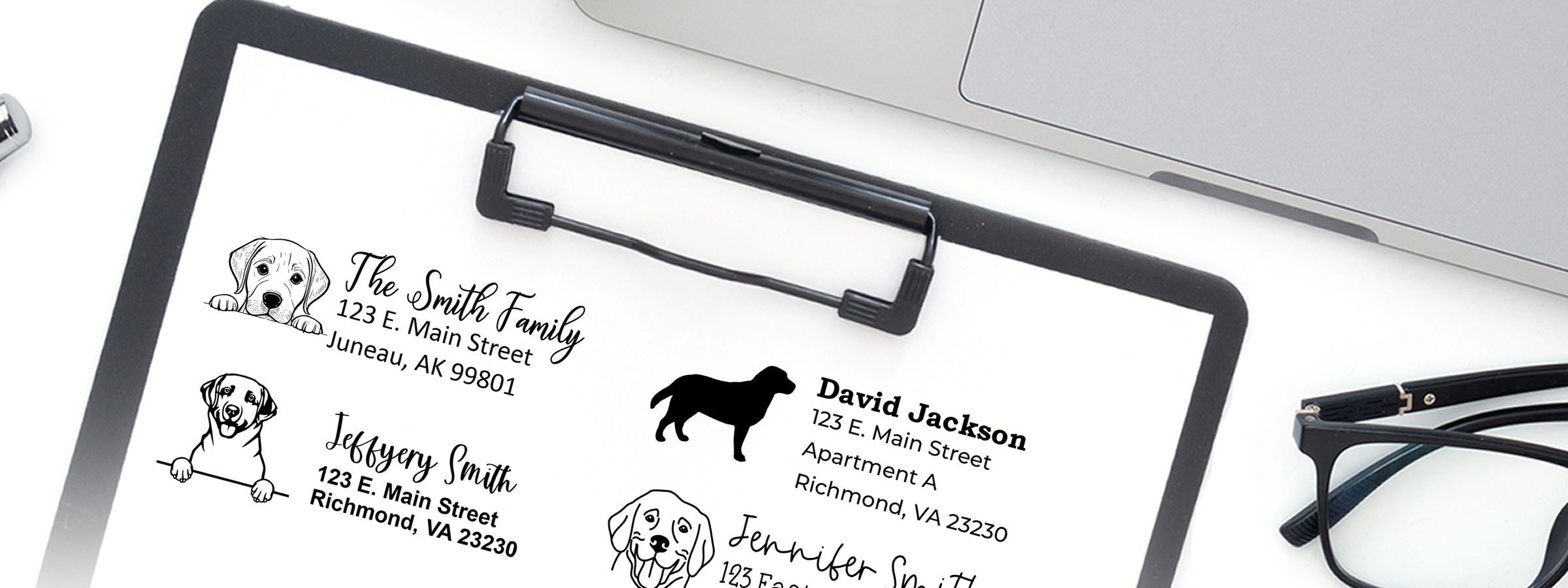 Sheet of custom dog-themed address labels on a clipboard, with laptop and glasses, featuring Labrador Dog Stamps and Custom Seals.