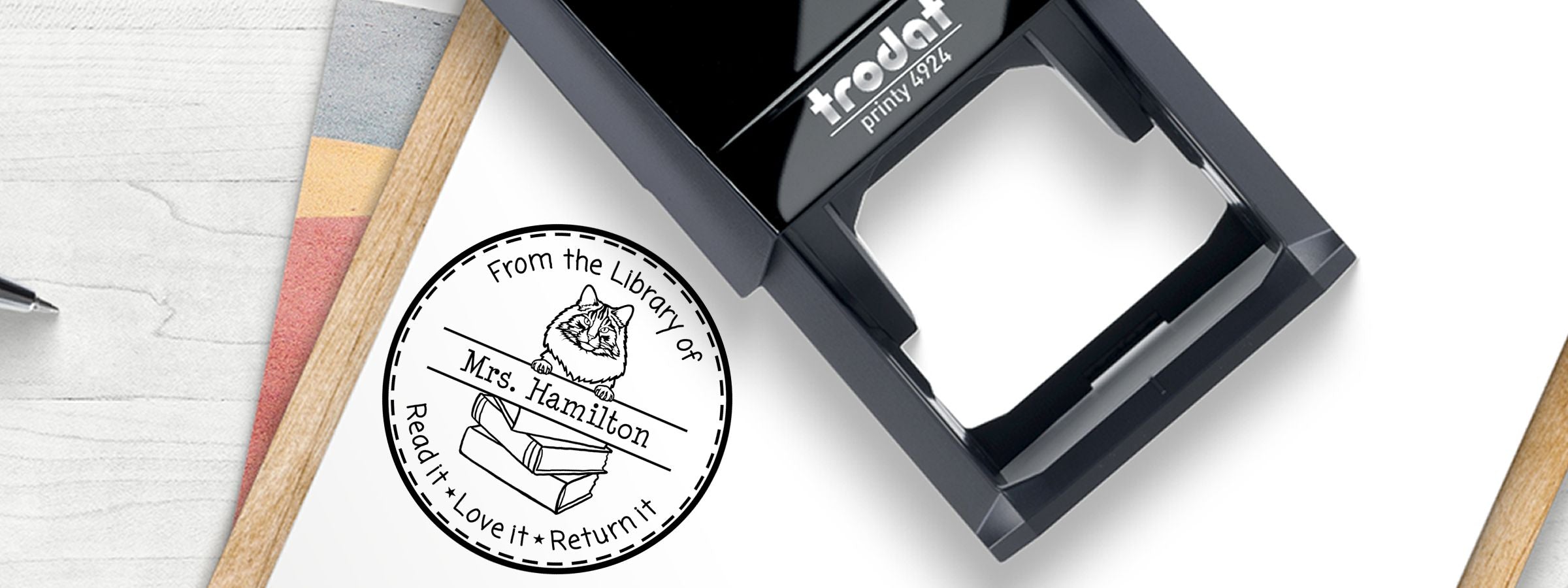 Black Trodat 4924 beside a library cat stamp reading “From the Library of Mrs. Hamilton,” with Norwegian Forest Cat Stamps and Custom Seals.