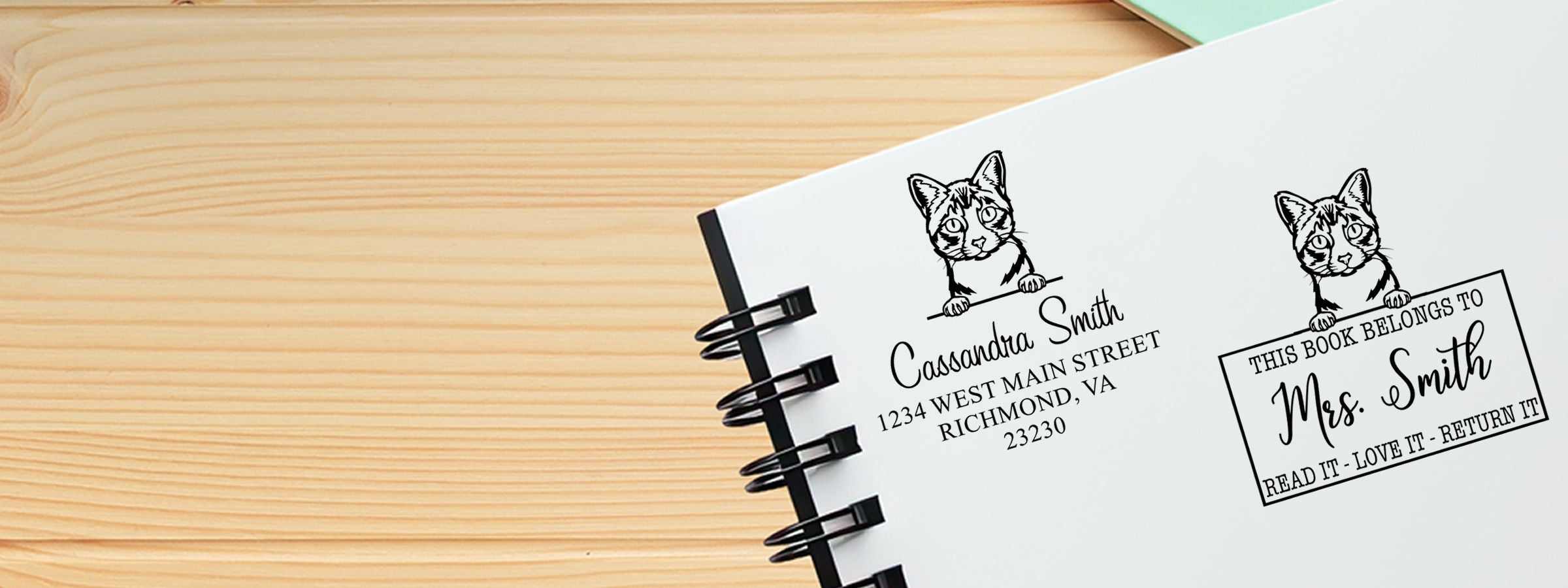 Spiral notebook on wood with cat art and personalized bookplate labels by Ojos Azules Cat Stamps and Custom Seals.