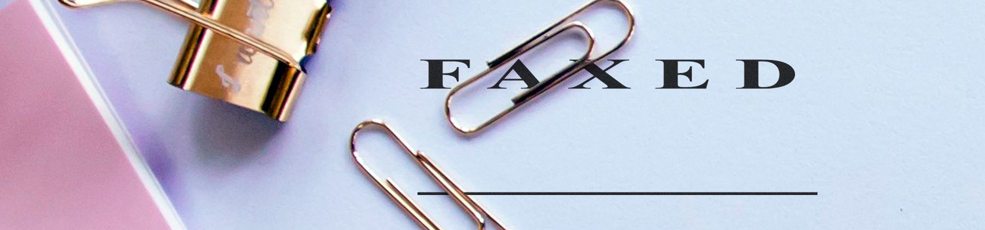 Xstamper Stock Stamps close-up of a gold binder clip and paper clips on a pastel background with “FAXED” and a blank line.