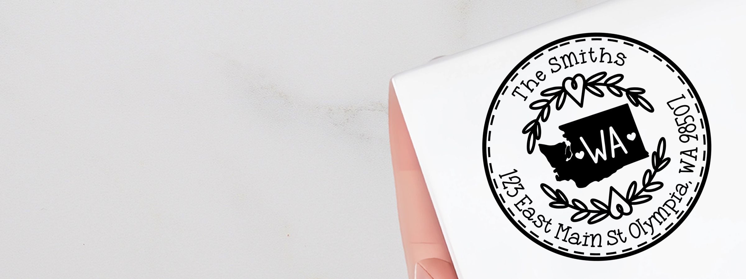 White folded card with black-and-white The Smiths logo, Olympia WA address, Washington silhouette and laurel wreath; Washington Designer Stamps and Seals.