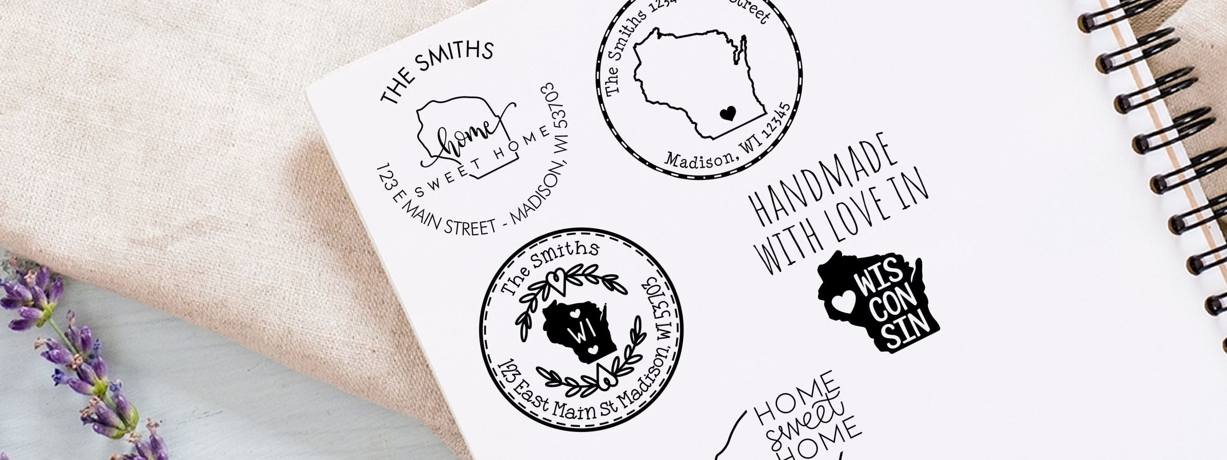 White spiral notebook featuring Wisconsin Designer Stamps and Seals, custom Wisconsin home decals for The Smiths, with maps and lavender.