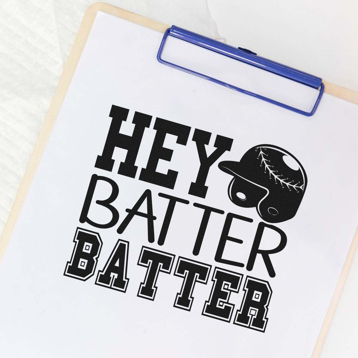 Baseball rubber stamp design with Hey Batter Batter text and helmet graphic on a clipboard.