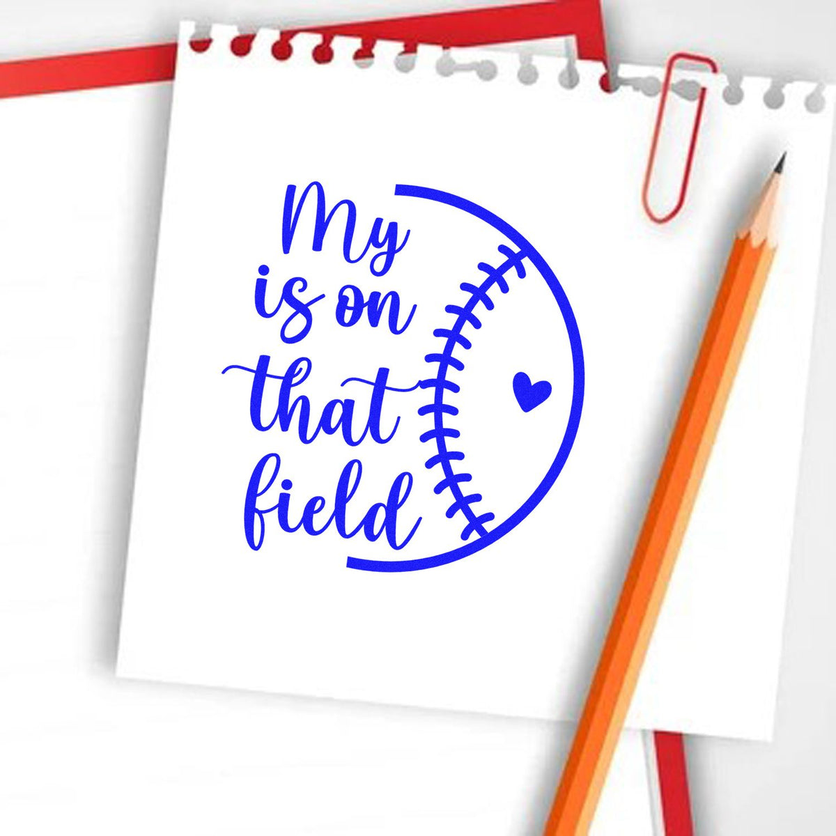 Baseball-themed rubber stamp design with notebook paper, pencil, and heart graphic reading My heart is on that field.