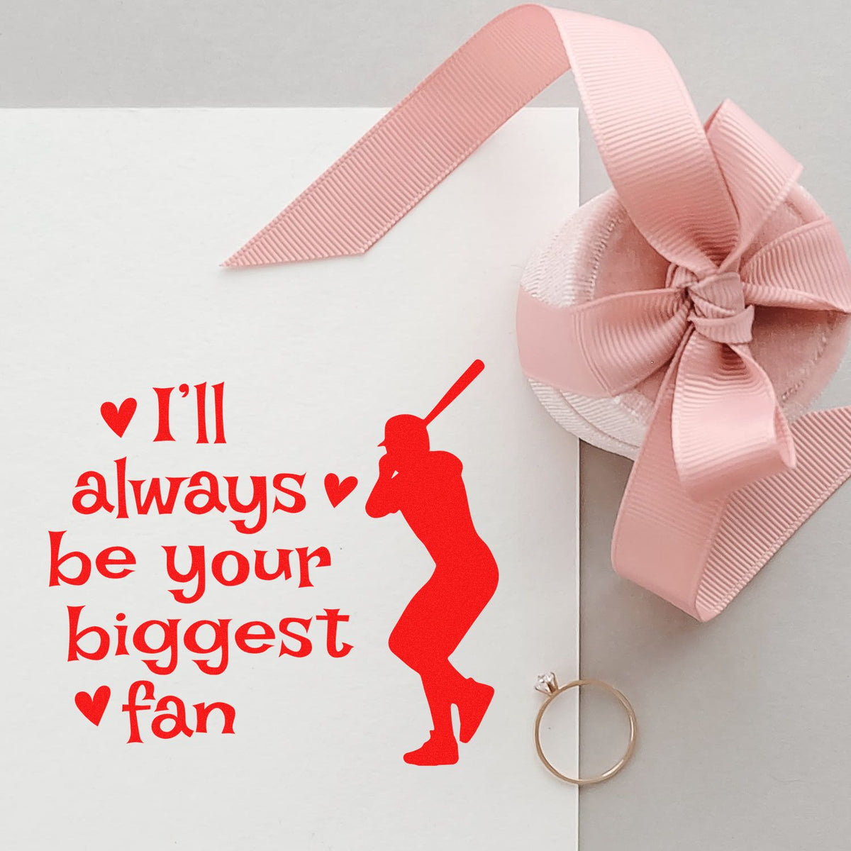 Red rubber stamp design reading Ill always be your biggest fan with baseball player silhouette, shown on gift packaging.