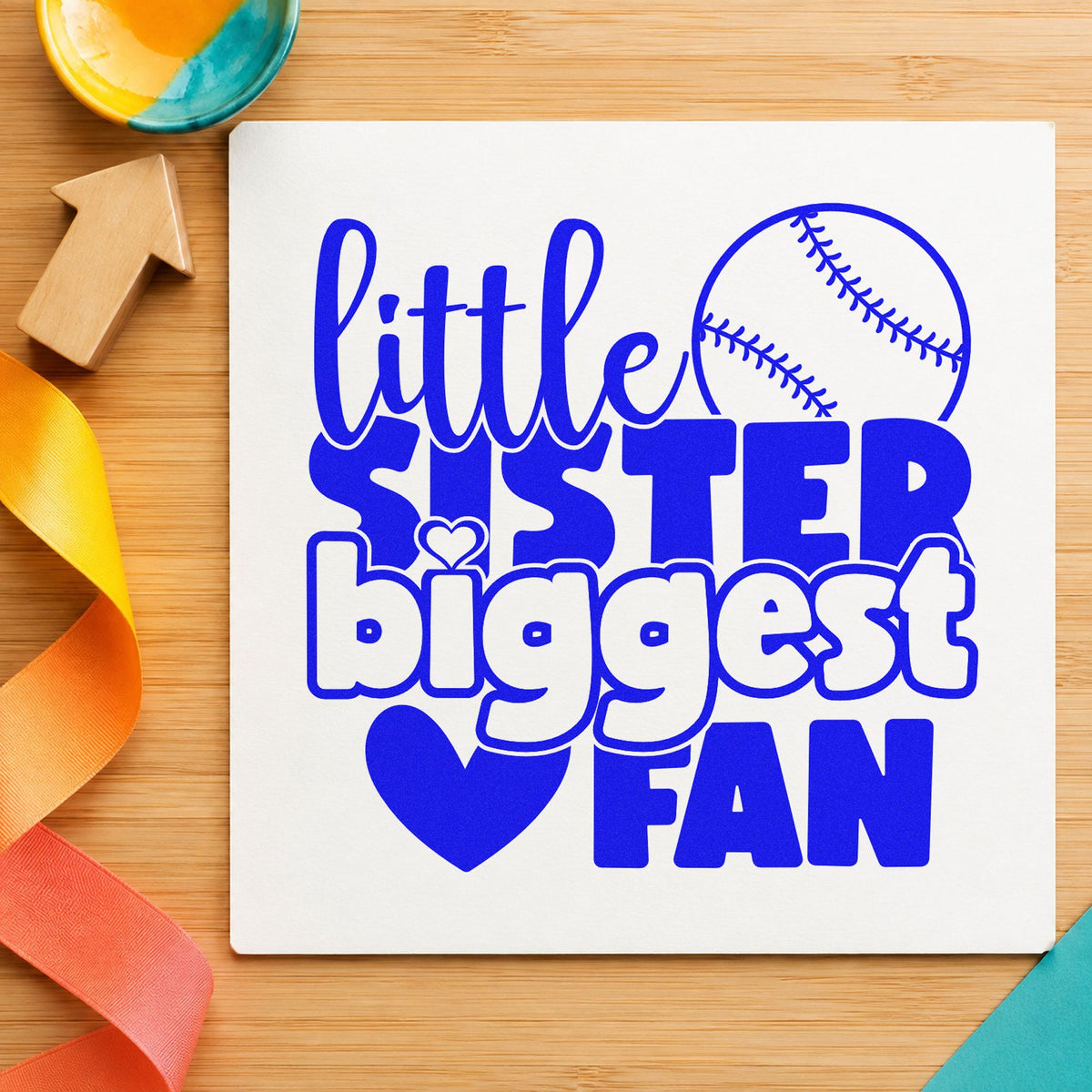 Little Sister Baseball Fan craft stamp imprinted in blue ink on paper, a design suited to party favor tags.