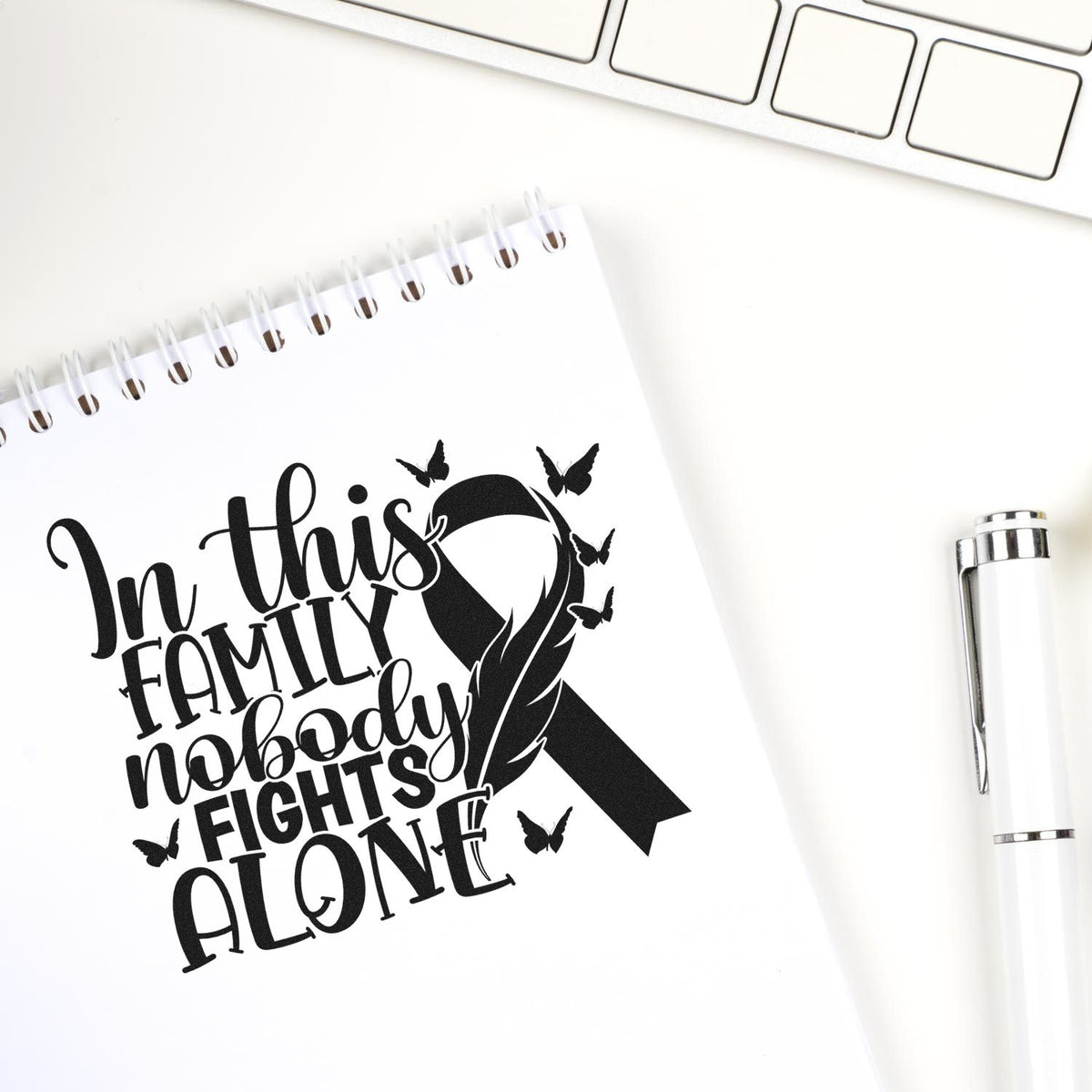Breast cancer awareness rubber stamp design with ribbon and In this family nobody fights alone quote.
