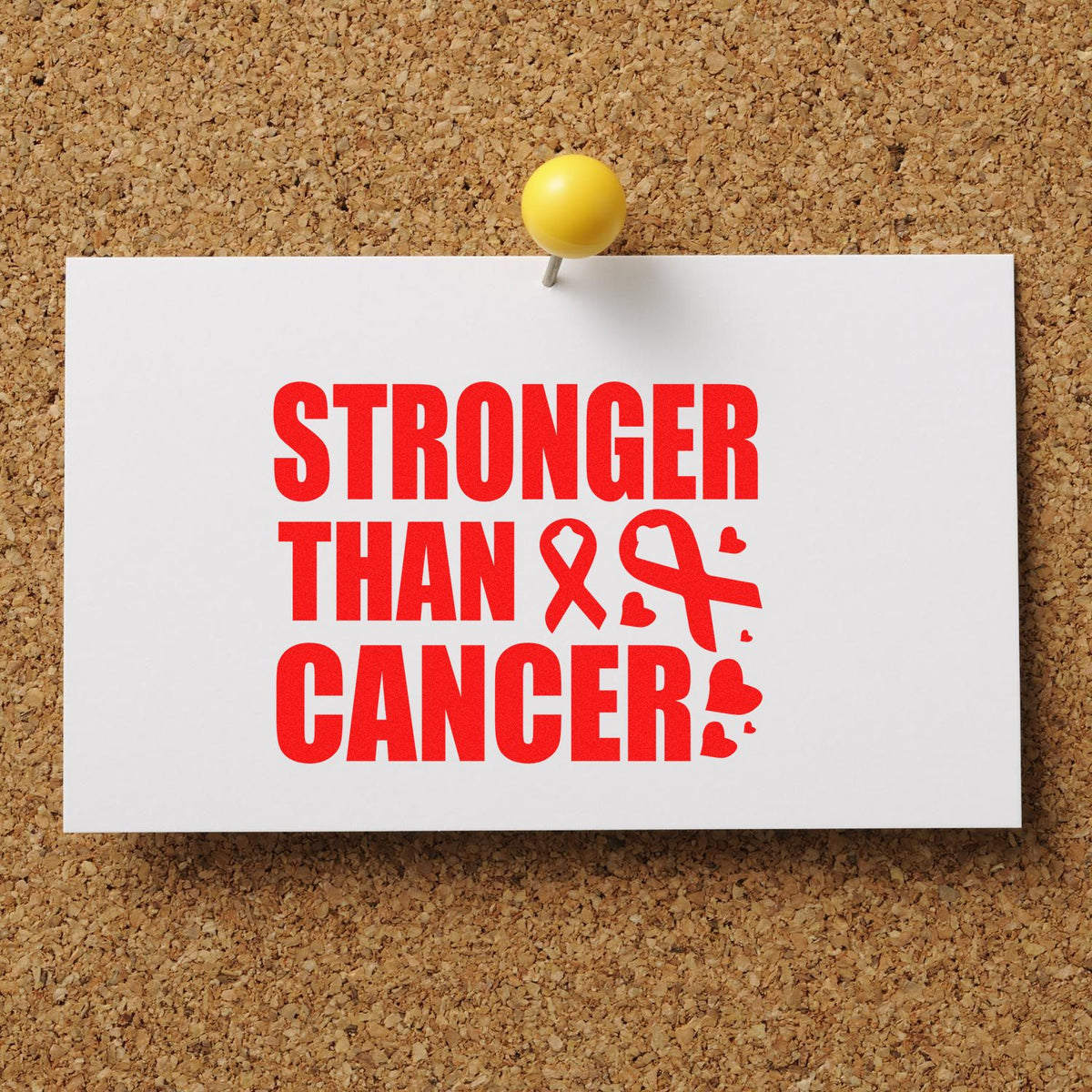 Cancer support rubber stamp design with bold red Stronger Than Cancer message and ribbon accents pinned on a corkboard.