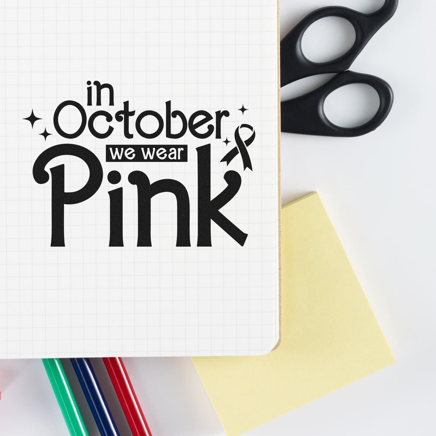 Breast cancer awareness rubber stamp design reading In October we wear Pink with ribbon for October pink fundraiser crafts.