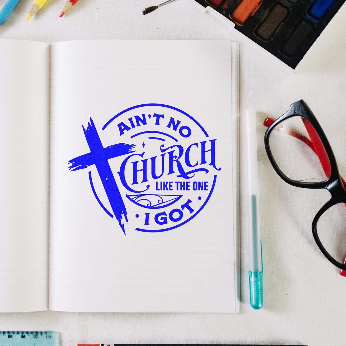 Church rubber stamp design on notebook with blue cross logo and Aint No Church Like the One I Got lettering.