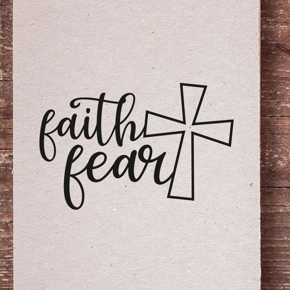 Christian rubber stamp design with faith and fear script beside a cross, ideal for inspirational faith-based crafts.