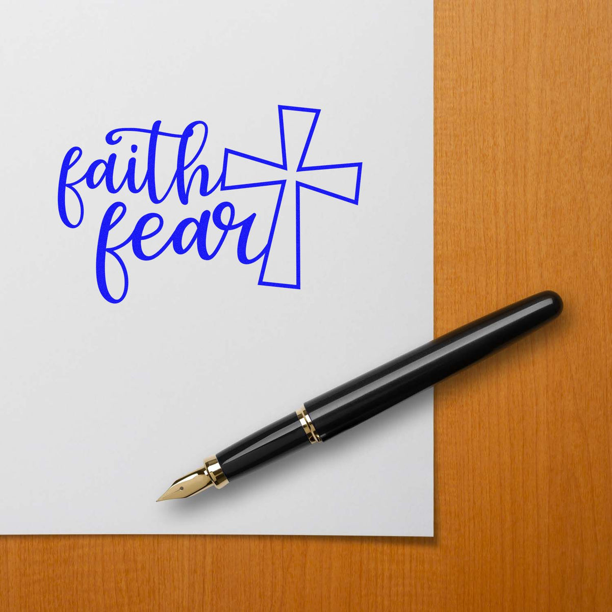Faith over fear rubber stamp with cross, blue imprint for Christian stationery, cards, and faith-based crafts.