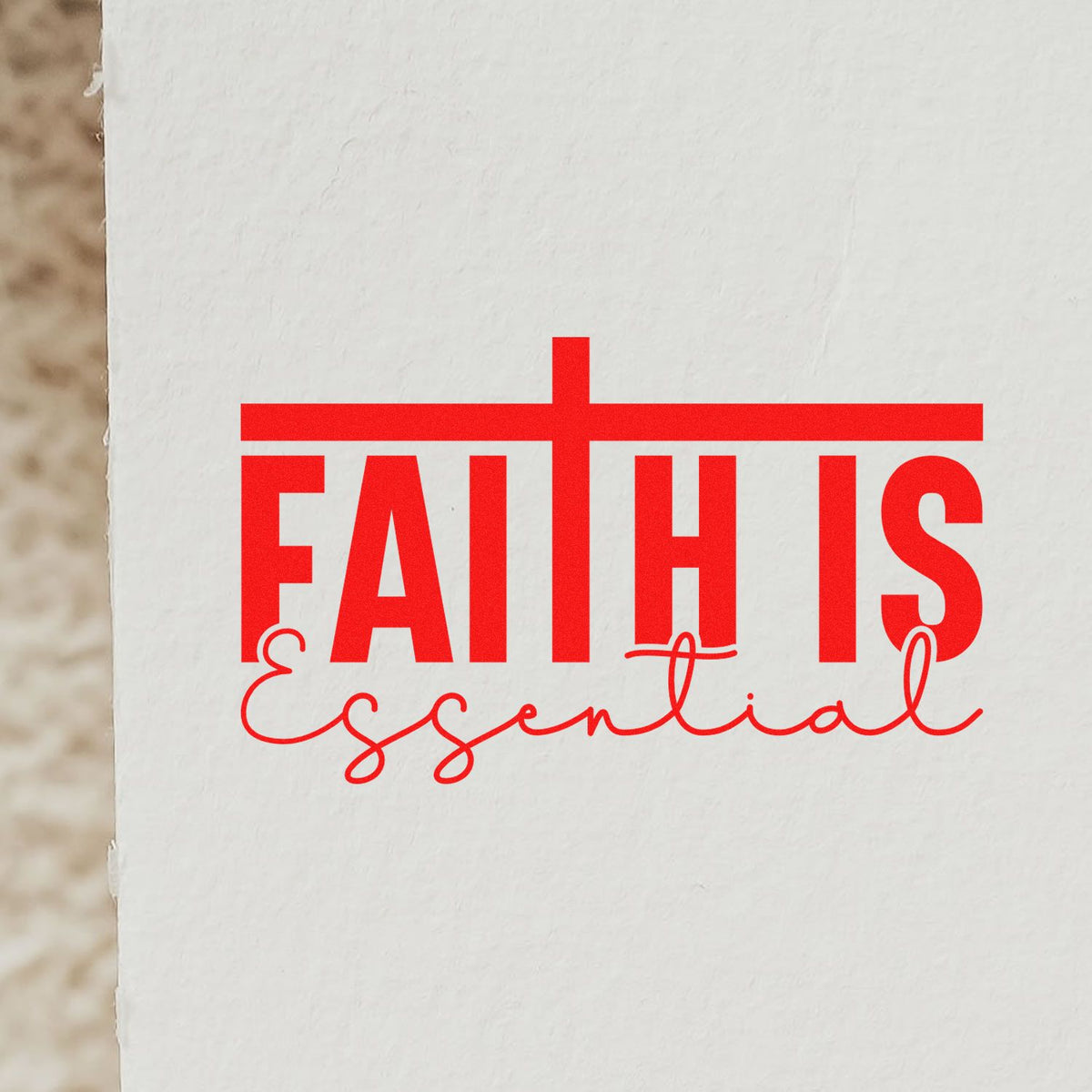 Faith is Essential rubber stamp design in red on white paper for Christian crafts and faith-based stationery.