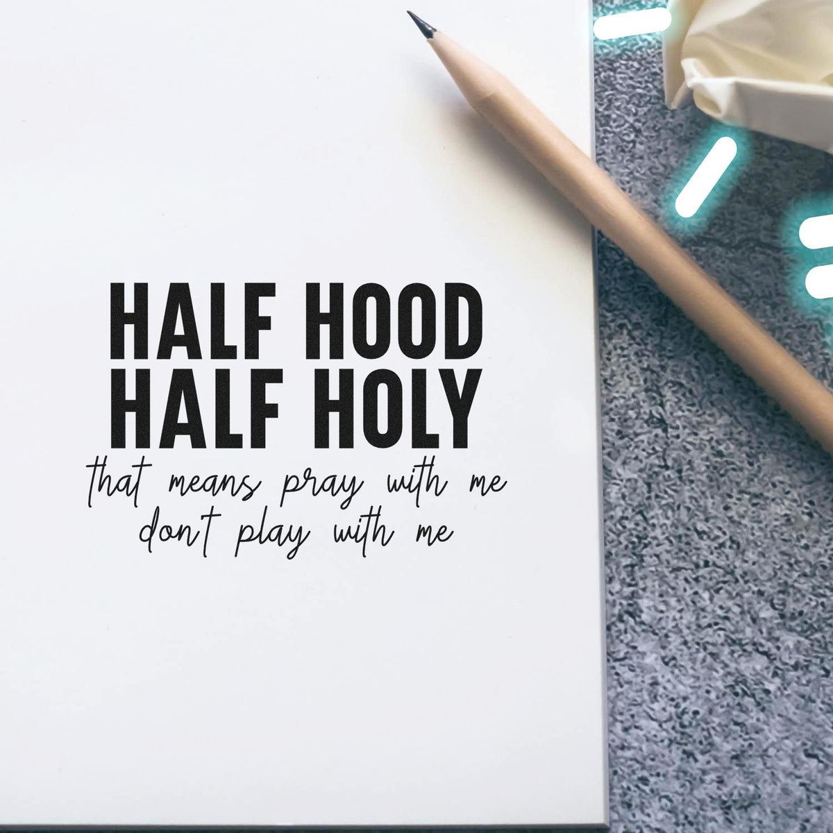 Custom rubber stamp design with bold text reading Half Hood Half Holy, plus handwritten subtext for faith-themed stationery.