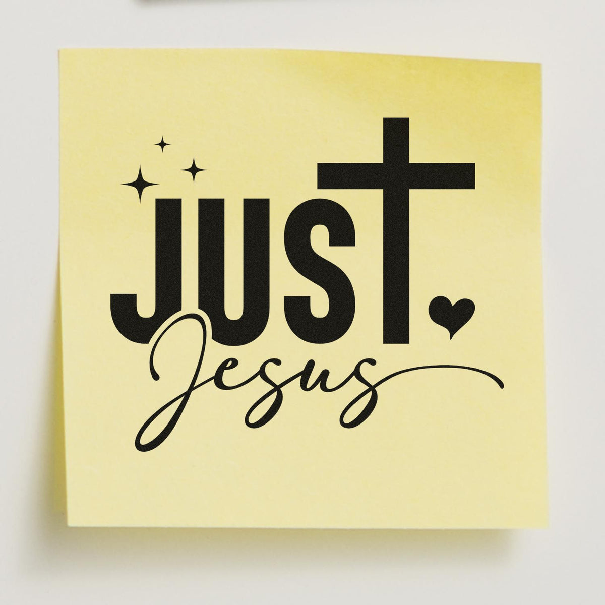 Faith-based rubber stamp design reading Just Jesus with cross, heart, and sparkle accents on a yellow note.