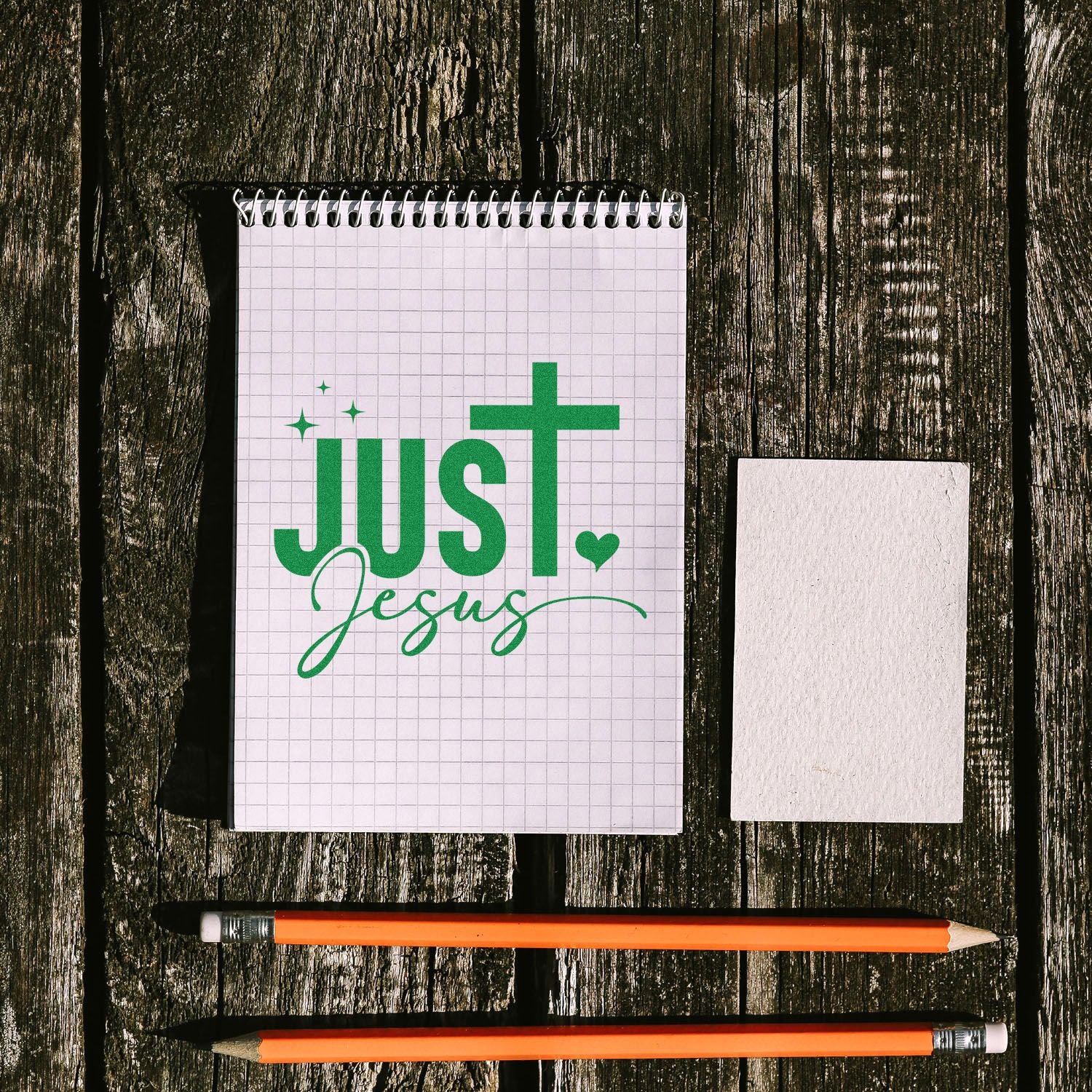Custom Christian rubber stamp mockup with Just Jesus design on a notebook beside a blank stamp impression card.