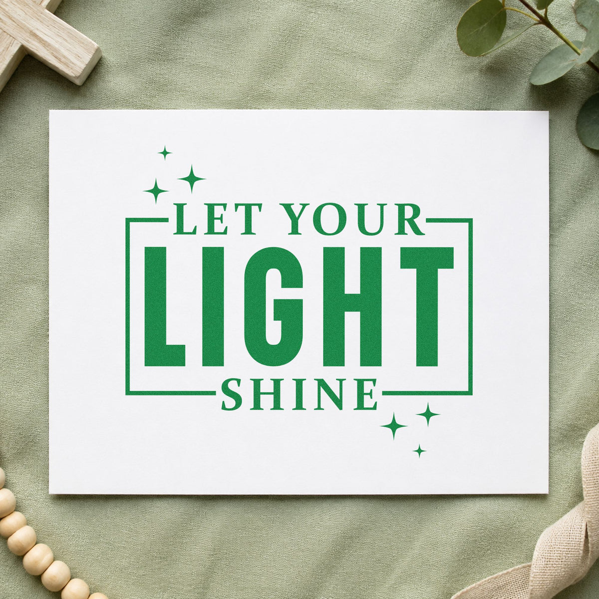 Let Your Light Shine craft stamp imprint in green ink on a handmade project, one idea being framed nursery art.