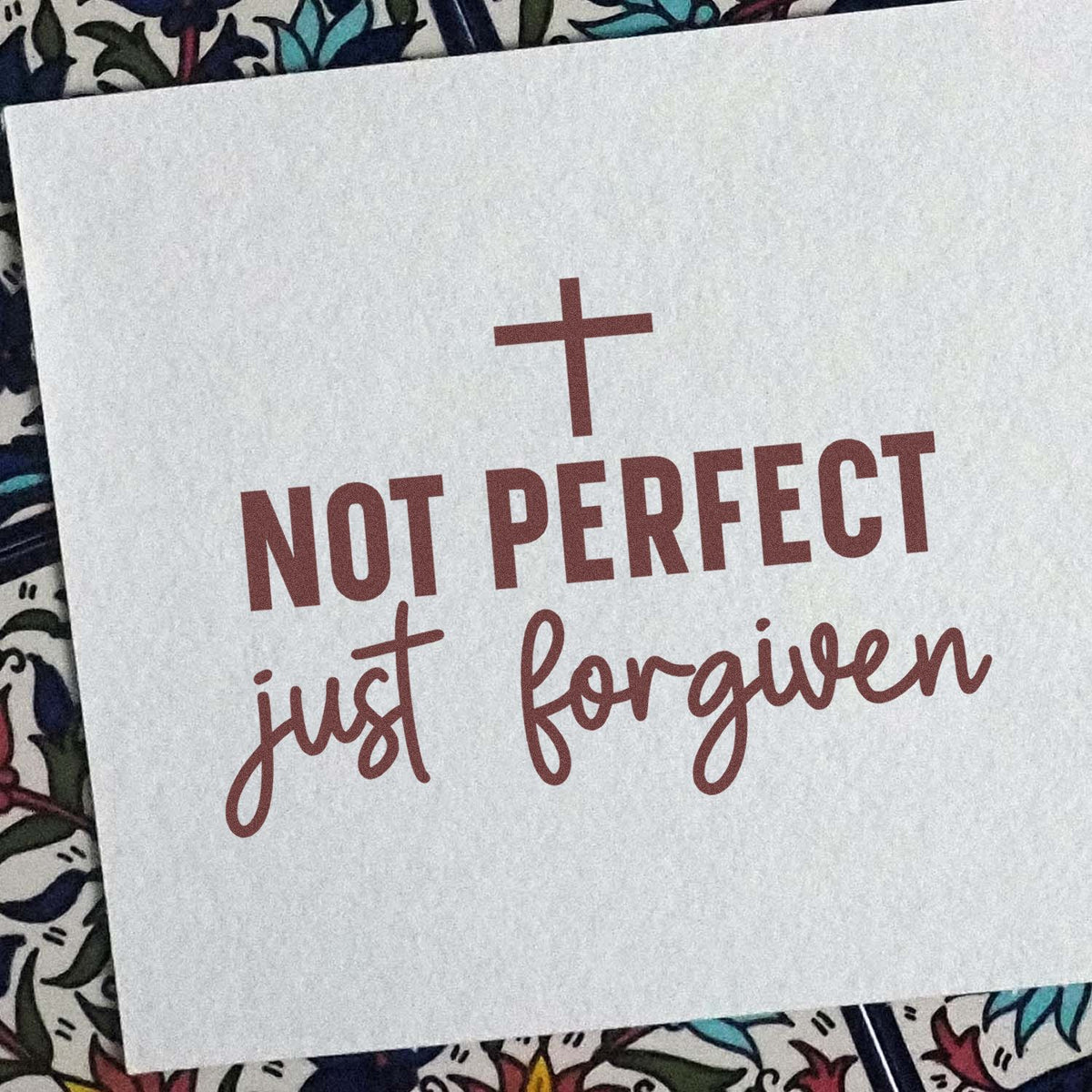Christian rubber stamp reading Not Perfect, Just Forgiven with cross, ideal for faith-based crafts and Bible journaling.