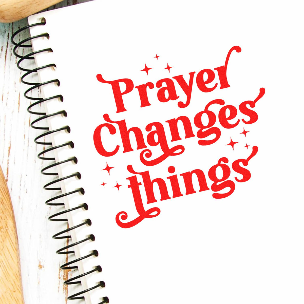 Prayer Changes Things rubber stamp design in red on a spiral notebook, perfect for faith journaling and Christian craft projects.