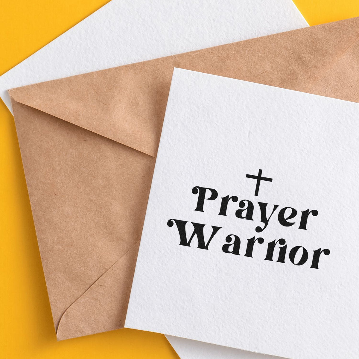 Christian Prayer Warrior rubber stamp design on a white card beside a kraft envelope for faith-based stationery.