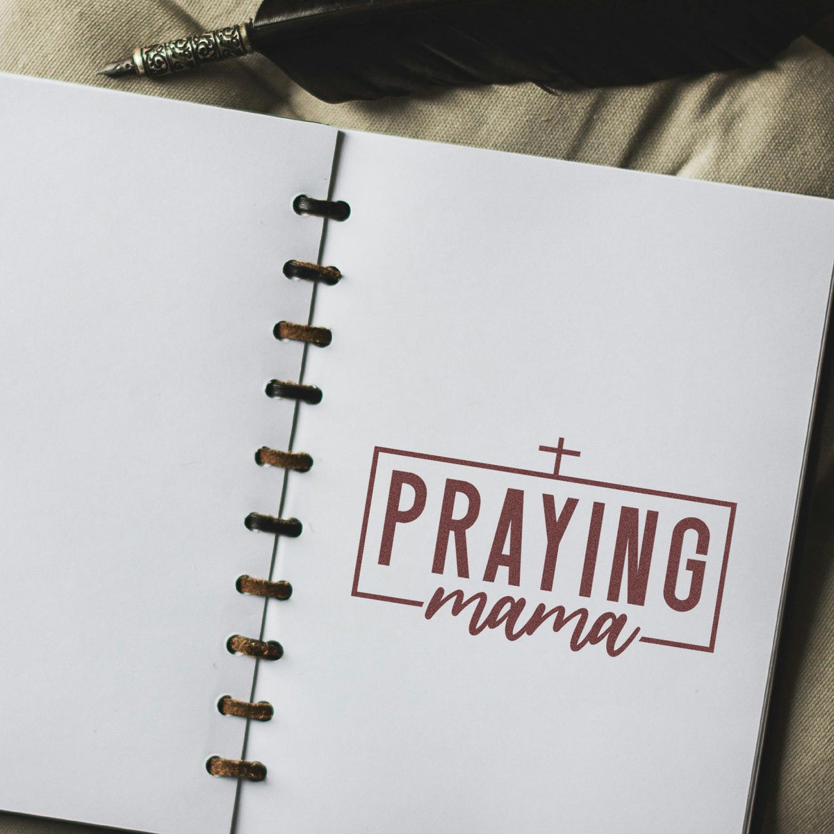 Custom rubber stamp with Praying Mama text on a notebook page, ideal for faith-based stationery and personalized gifts.