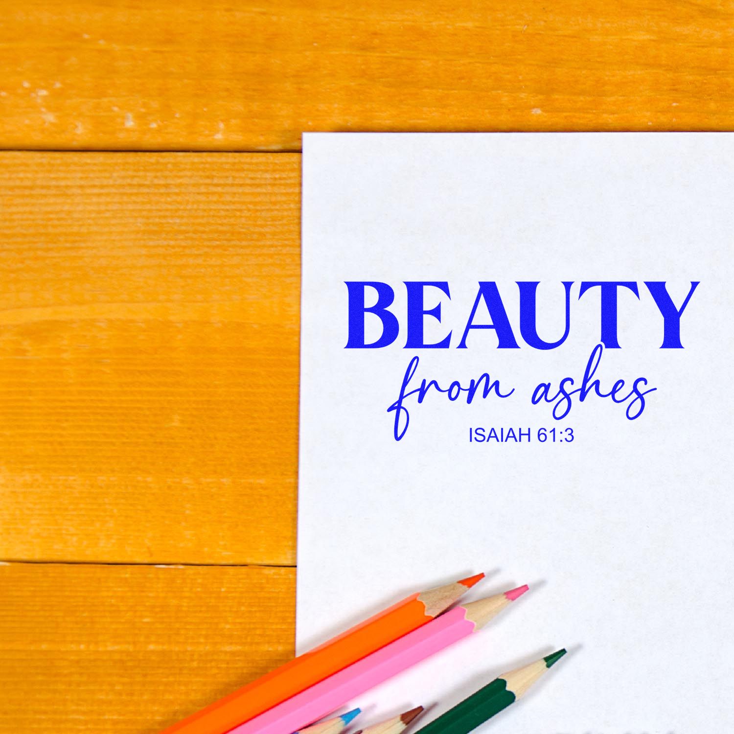 Christian rubber stamp with Beauty from Ashes Isaiah 61:3 design on paper, styled with colored pencils.
