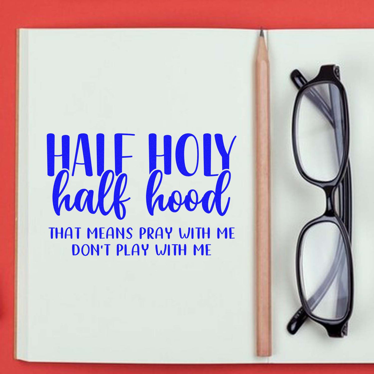 Half Holy Half Hood custom rubber stamp design with Pray with me, dont play with me in a notebook mockup.