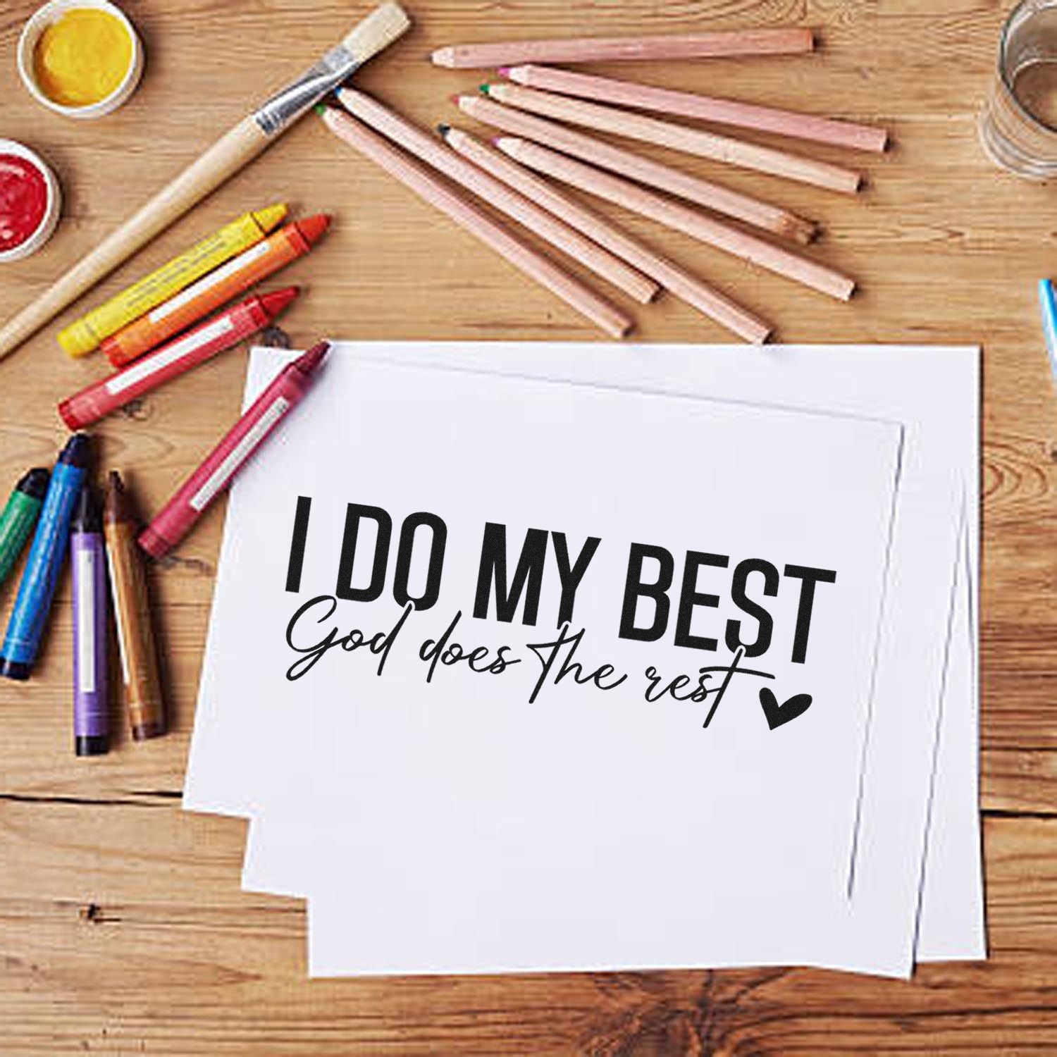 Inspirational rubber stamp design on paper reading I Do My Best, God Does the Rest with craft supplies nearby.