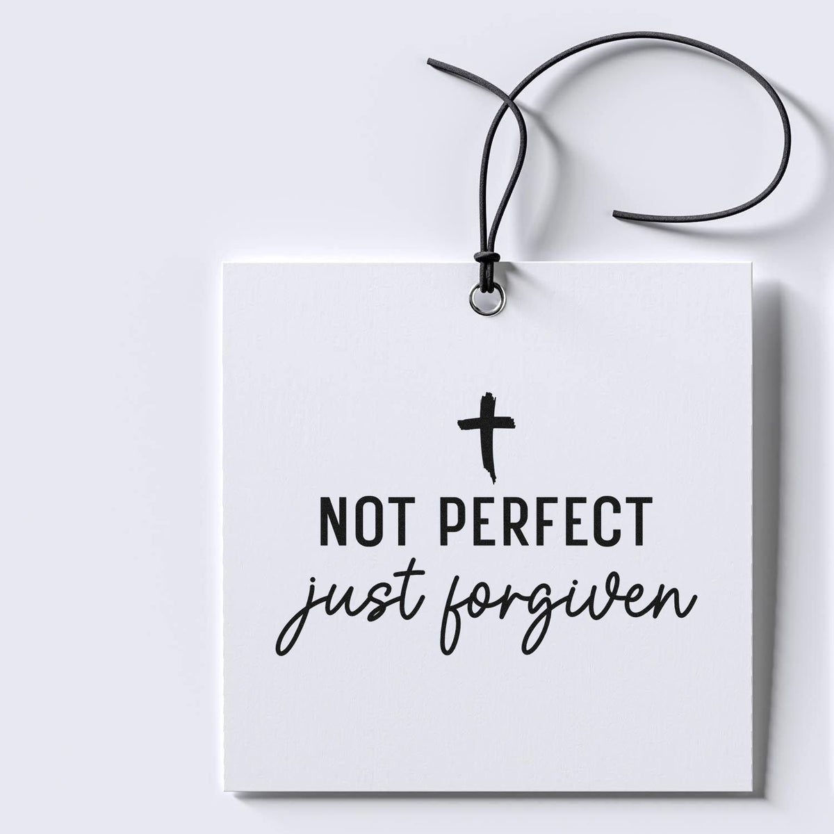 Christian rubber stamp design with cross and Not Perfect, Just Forgiven faith-based inspirational quote on gift tag.