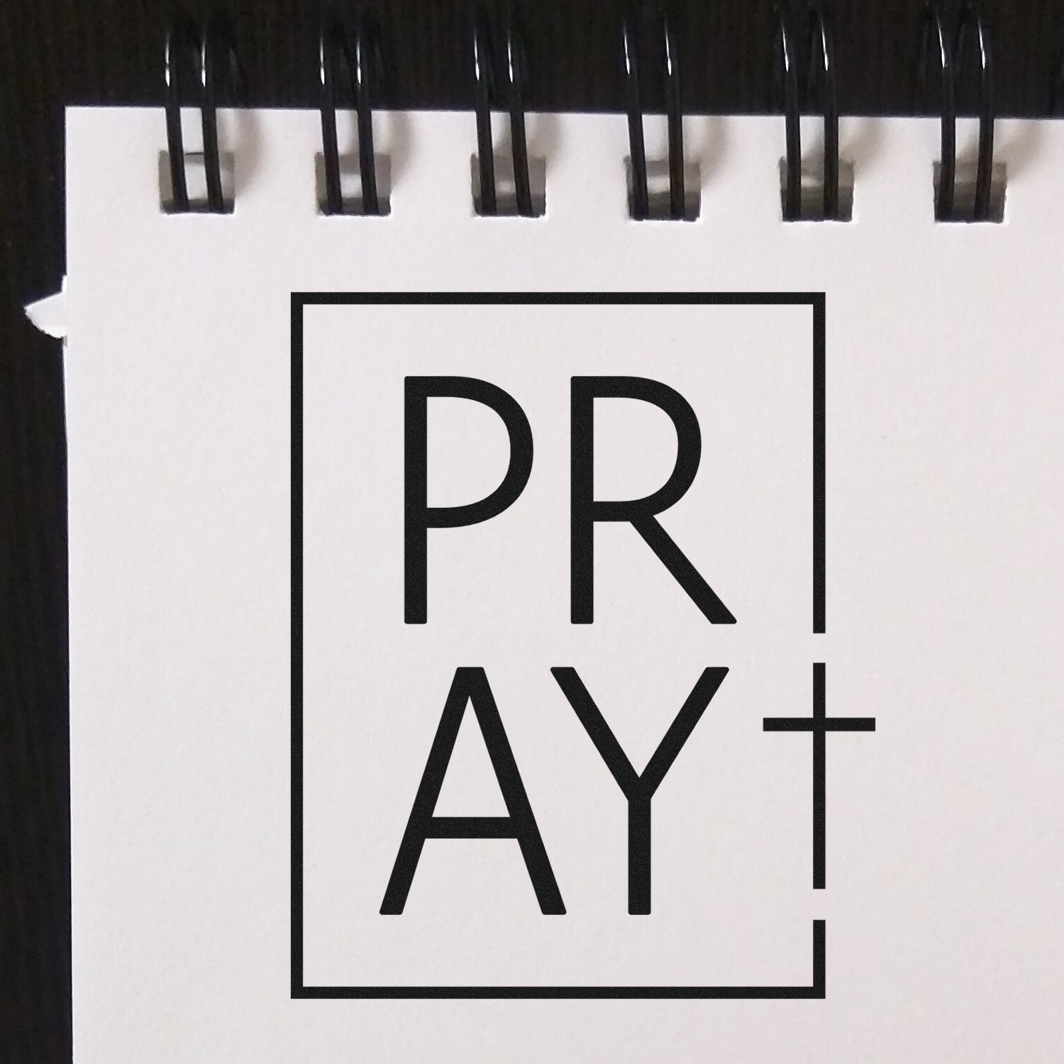 PRAY+ rubber stamp design with bold black lettering in a boxed logo, ideal for faith-based stationery and craft projects.