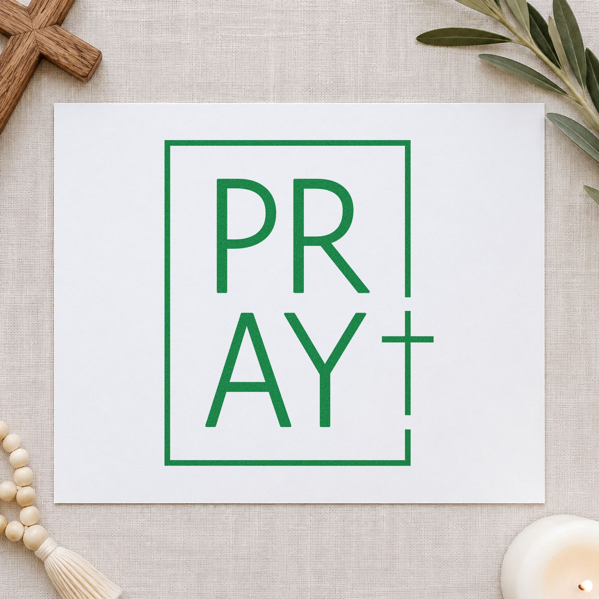 Pray Minimal Cross craft stamp imprint in green ink on a handmade project, one idea being door signs.
