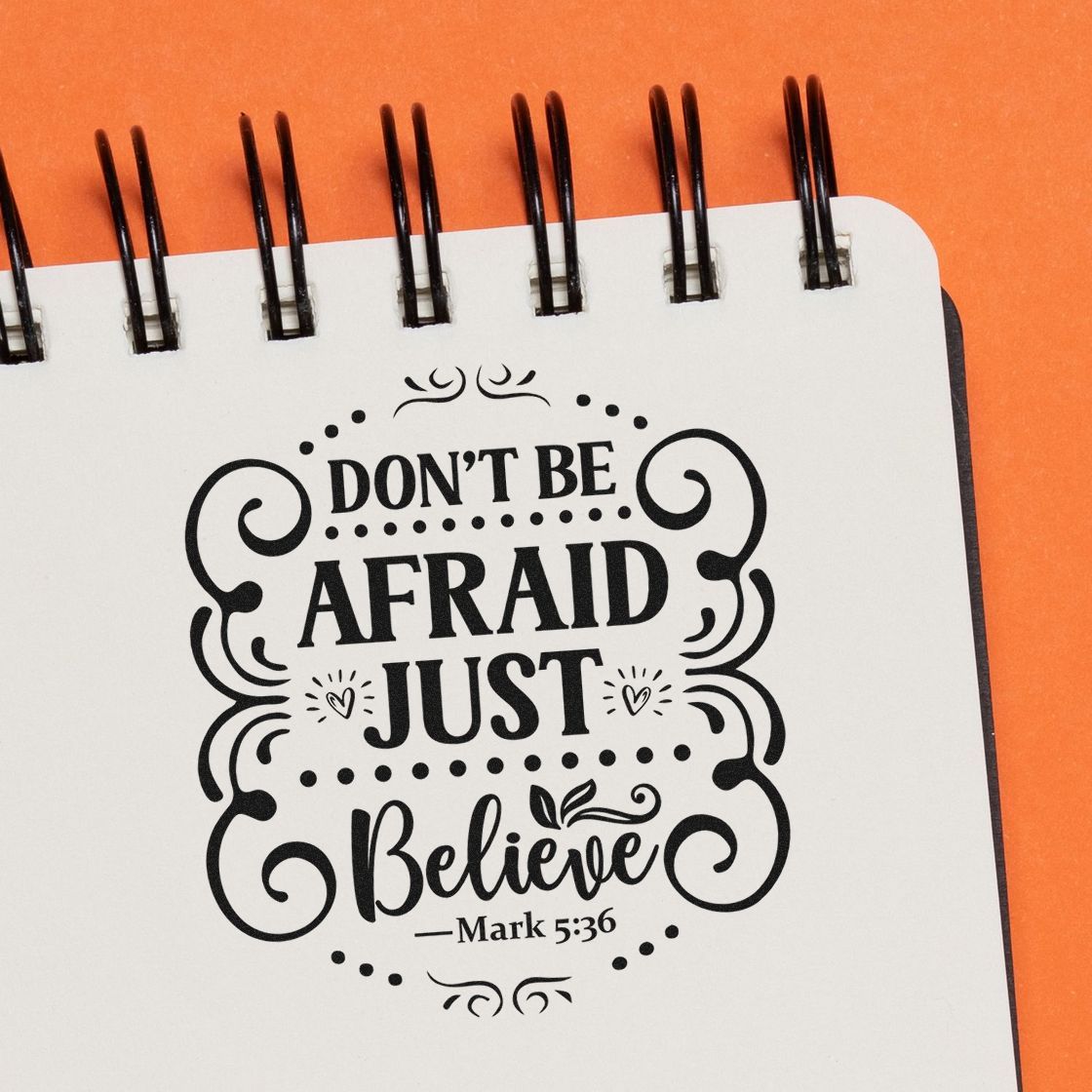 Bible verse rubber stamp design reading Dont Be Afraid, Just Believe from Mark 5:36 on a notebook page.