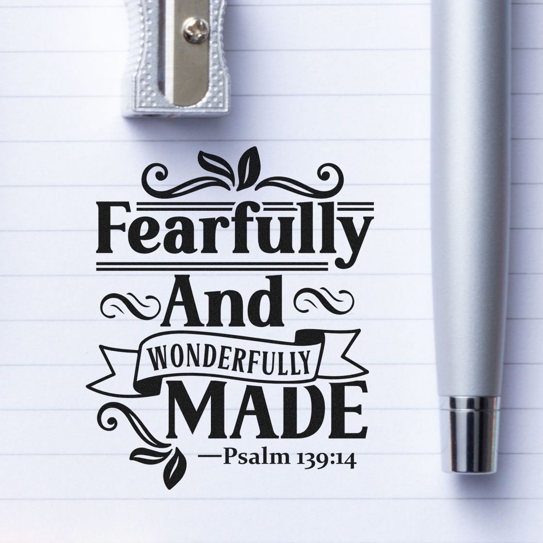Psalm 139:14 rubber stamp design reading Fearfully and Wonderfully Made on lined paper with decorative script and pen