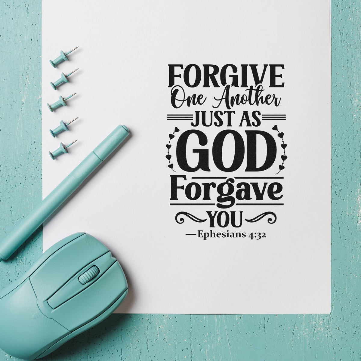 Christian rubber stamp design with Ephesians 4:32 quote, Forgive One Another Just As God Forgave You, shown with teal stamp tools.