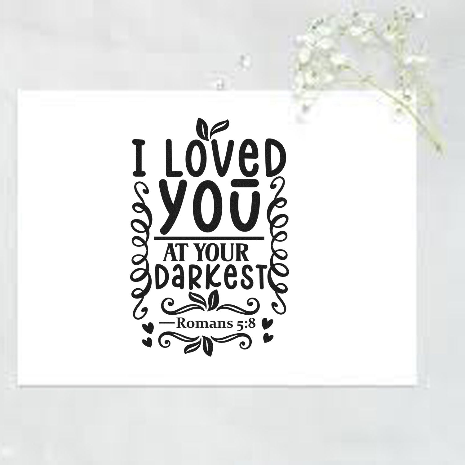 Christian rubber stamp design with I loved you at your darkest Bible verse Romans 5:8 and decorative flourishes.