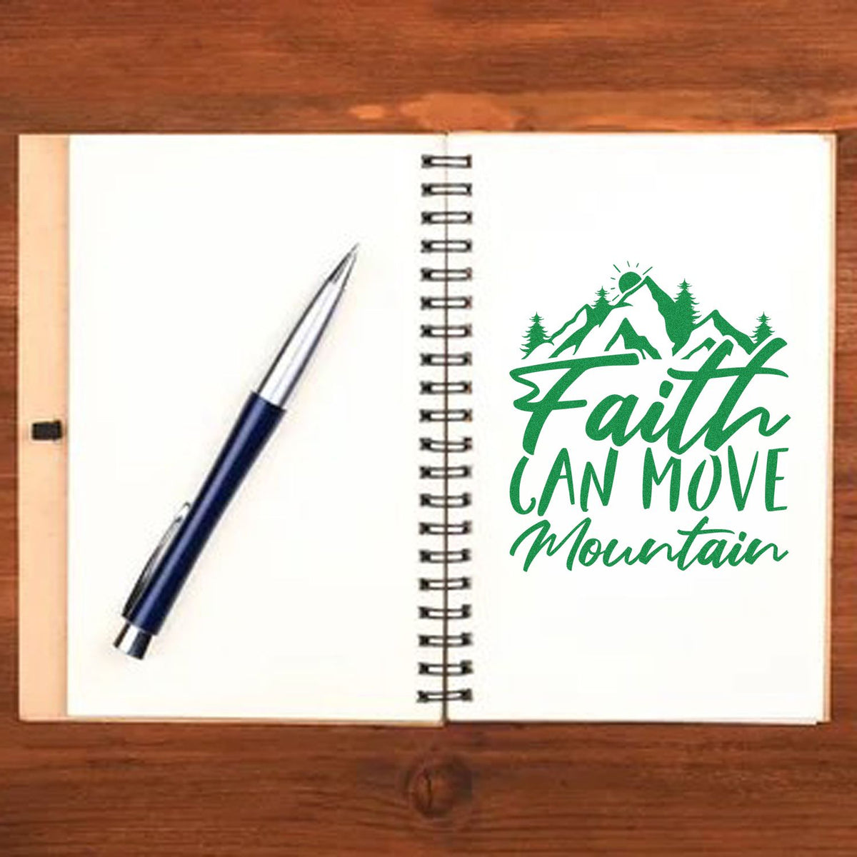 Faith Can Move Mountain rubber stamp design on an open notebook with pen, ideal for Christian journaling and faith-based crafting.