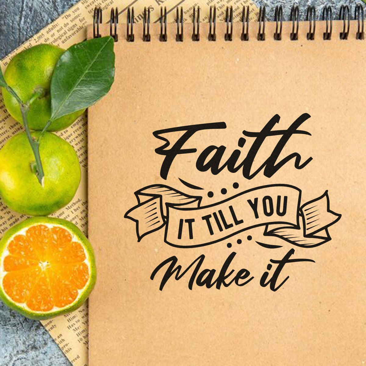 Faith it till you make it rubber stamp on kraft notebook, ideal for faith-inspired journaling, scrapbooking, and crafts.